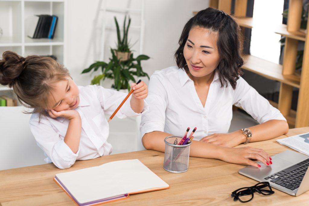 Mother and daughter studying at the desk